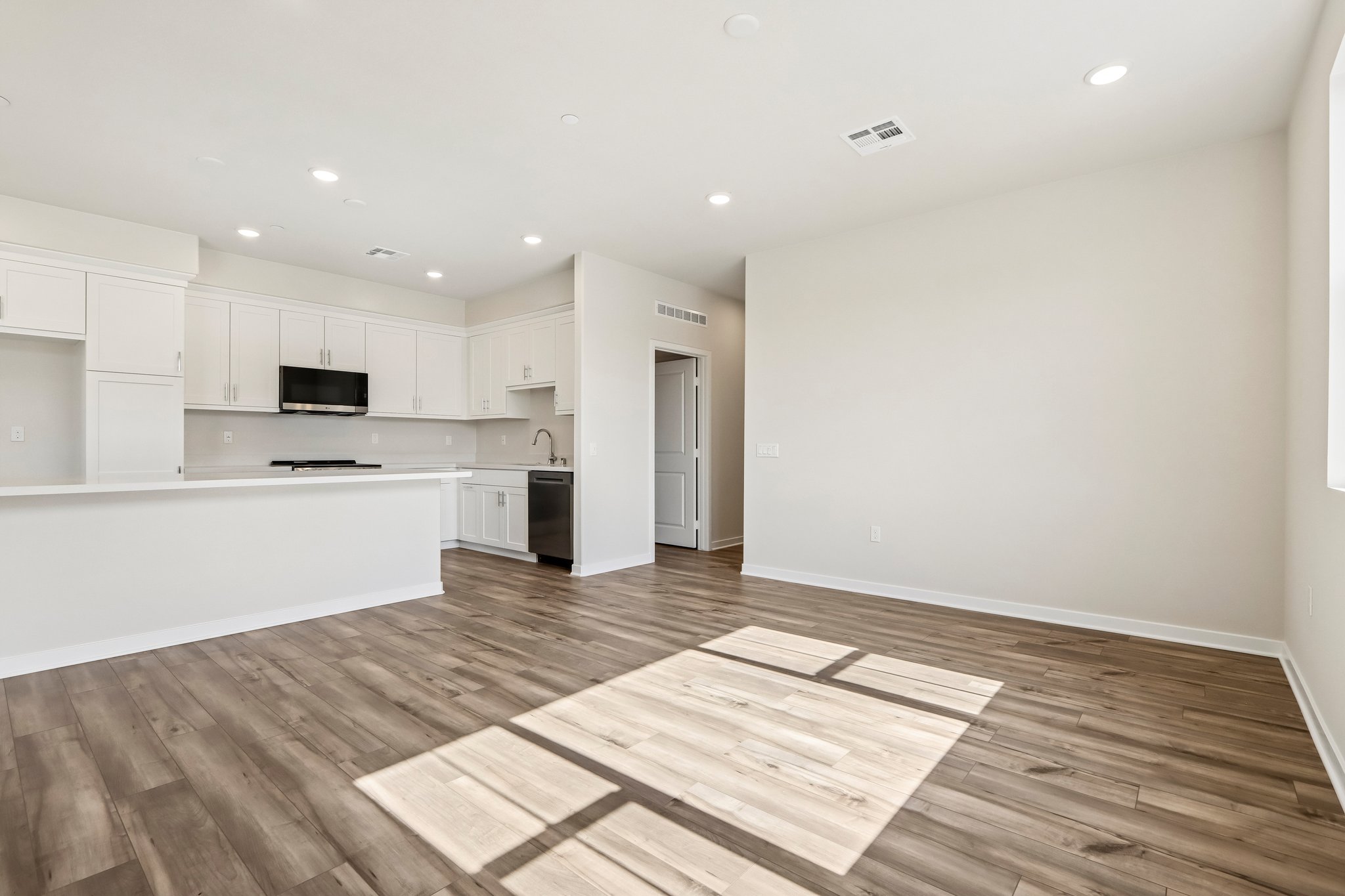 A kitchen with white cabinets.