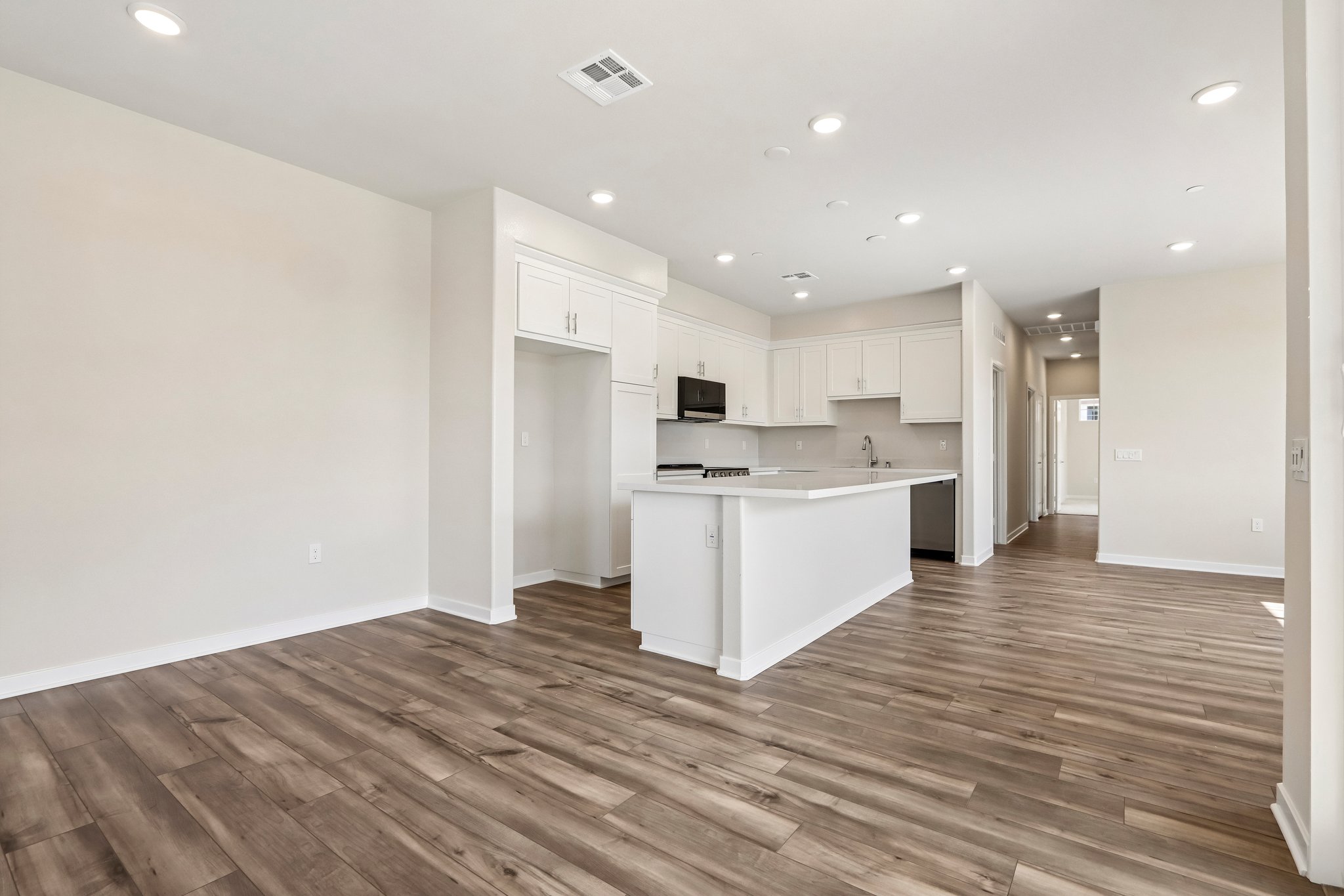A large kitchen with white cabinets.
