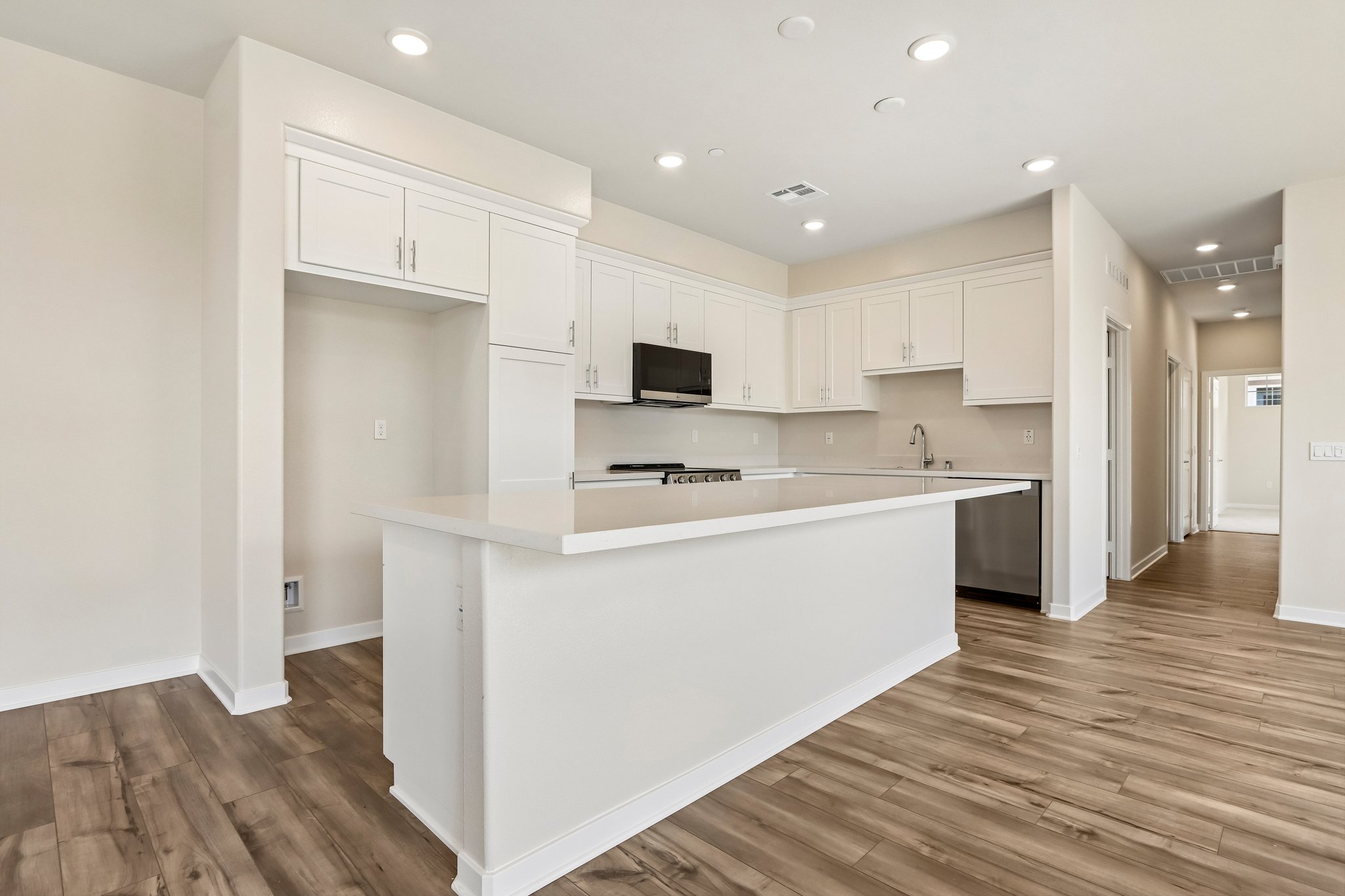 A kitchen with white cabinets.