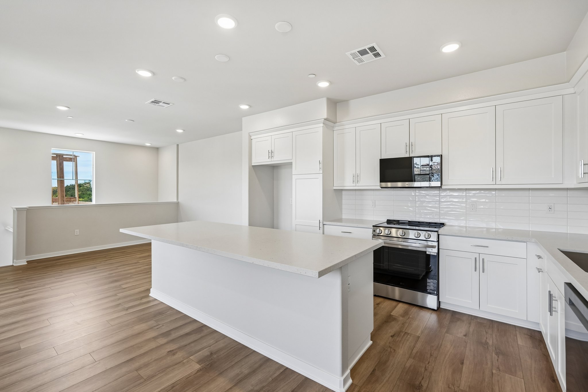 A kitchen with white cabinets.
