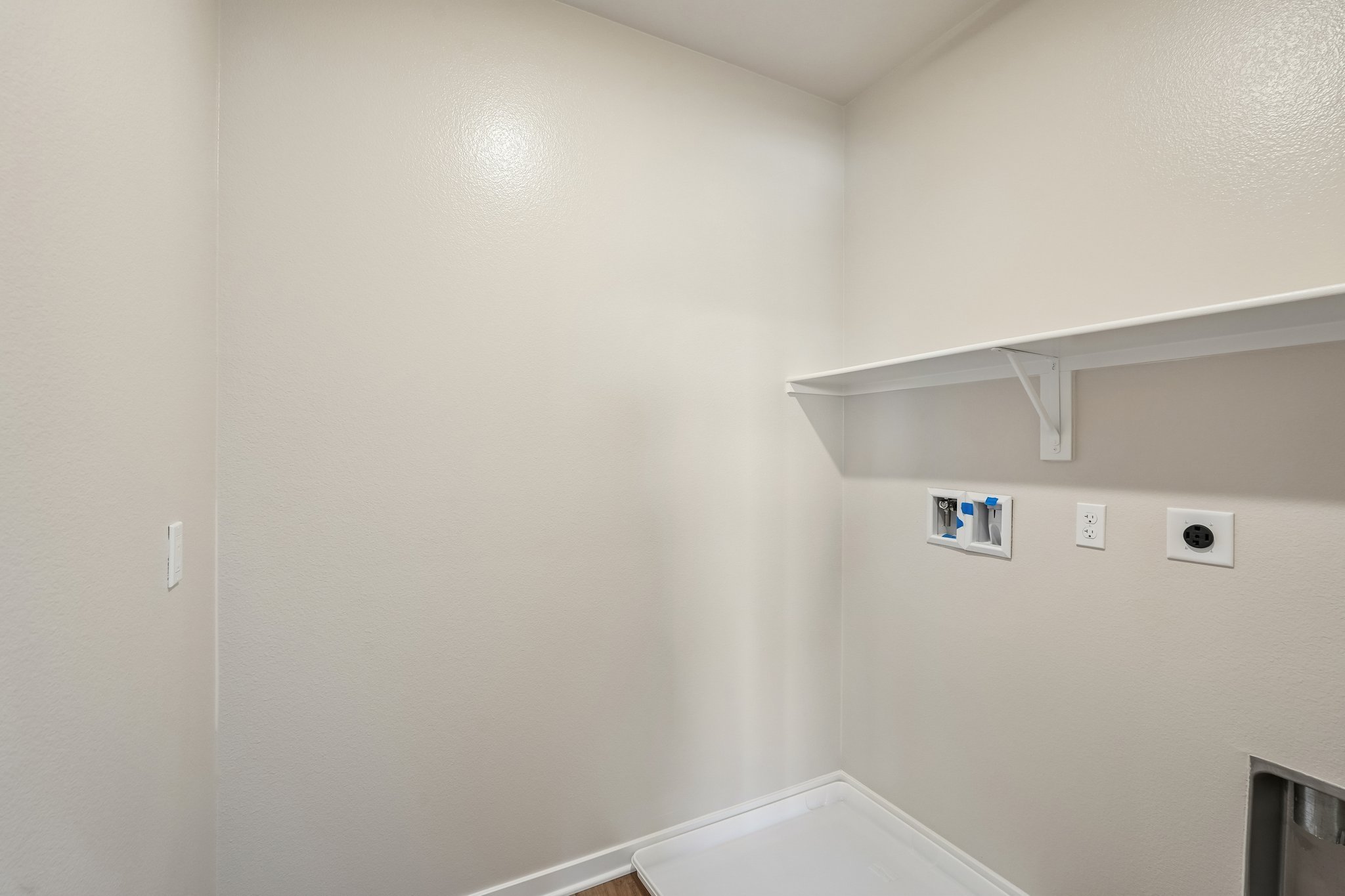 A white wall with a light on it.