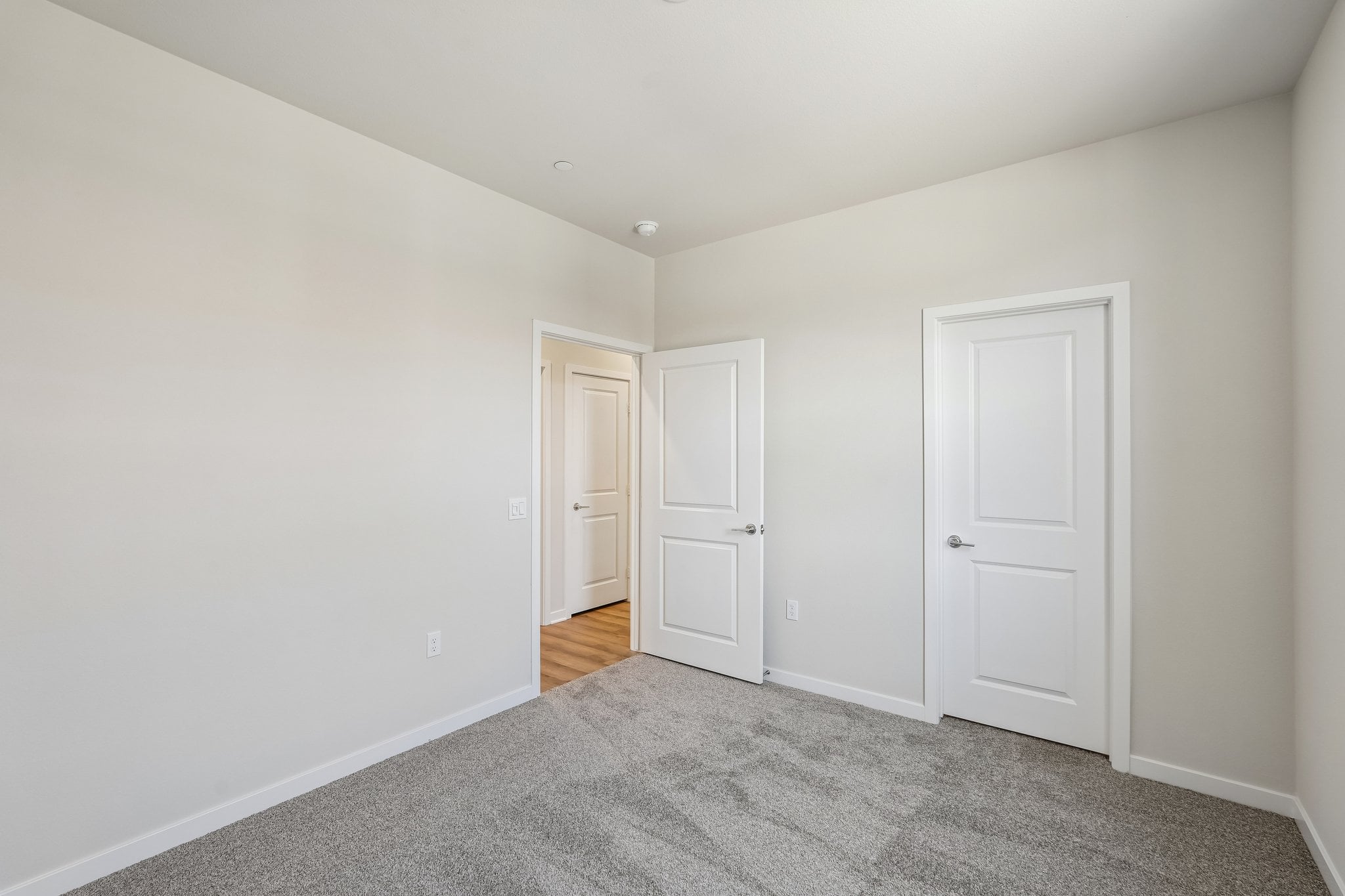 A hallway with white doors.
