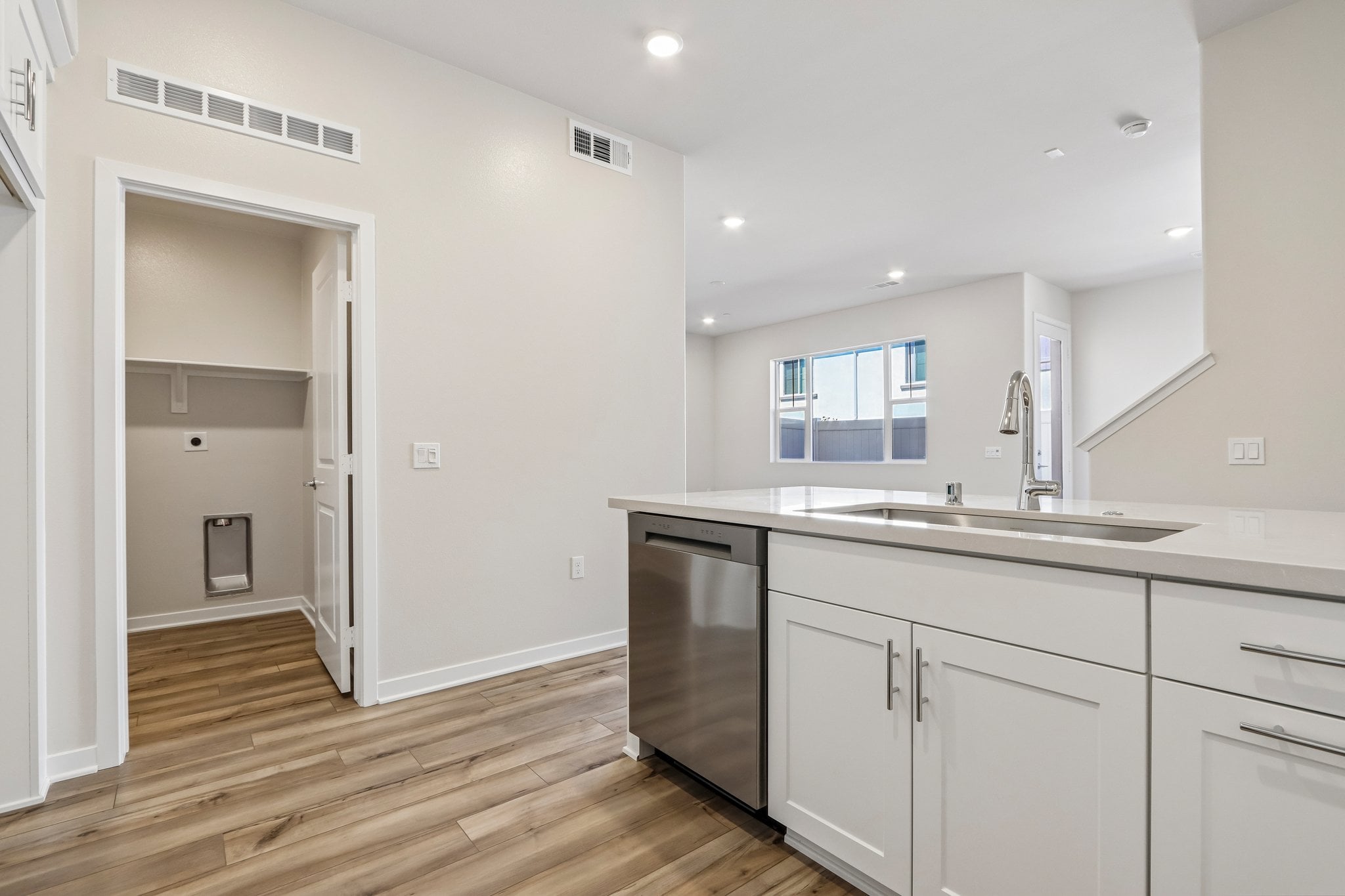 A kitchen with white cabinets.