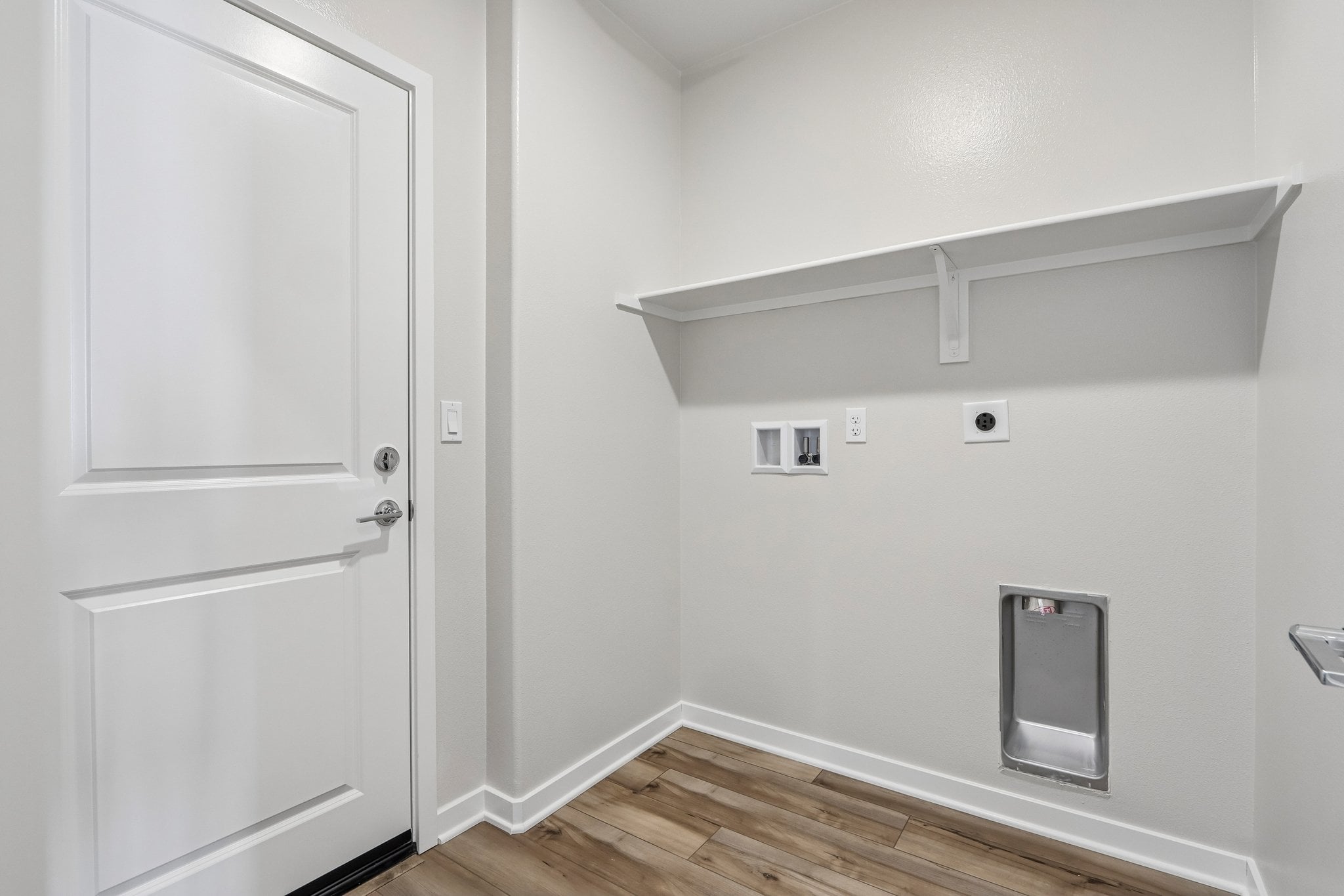 A white room with a white door.