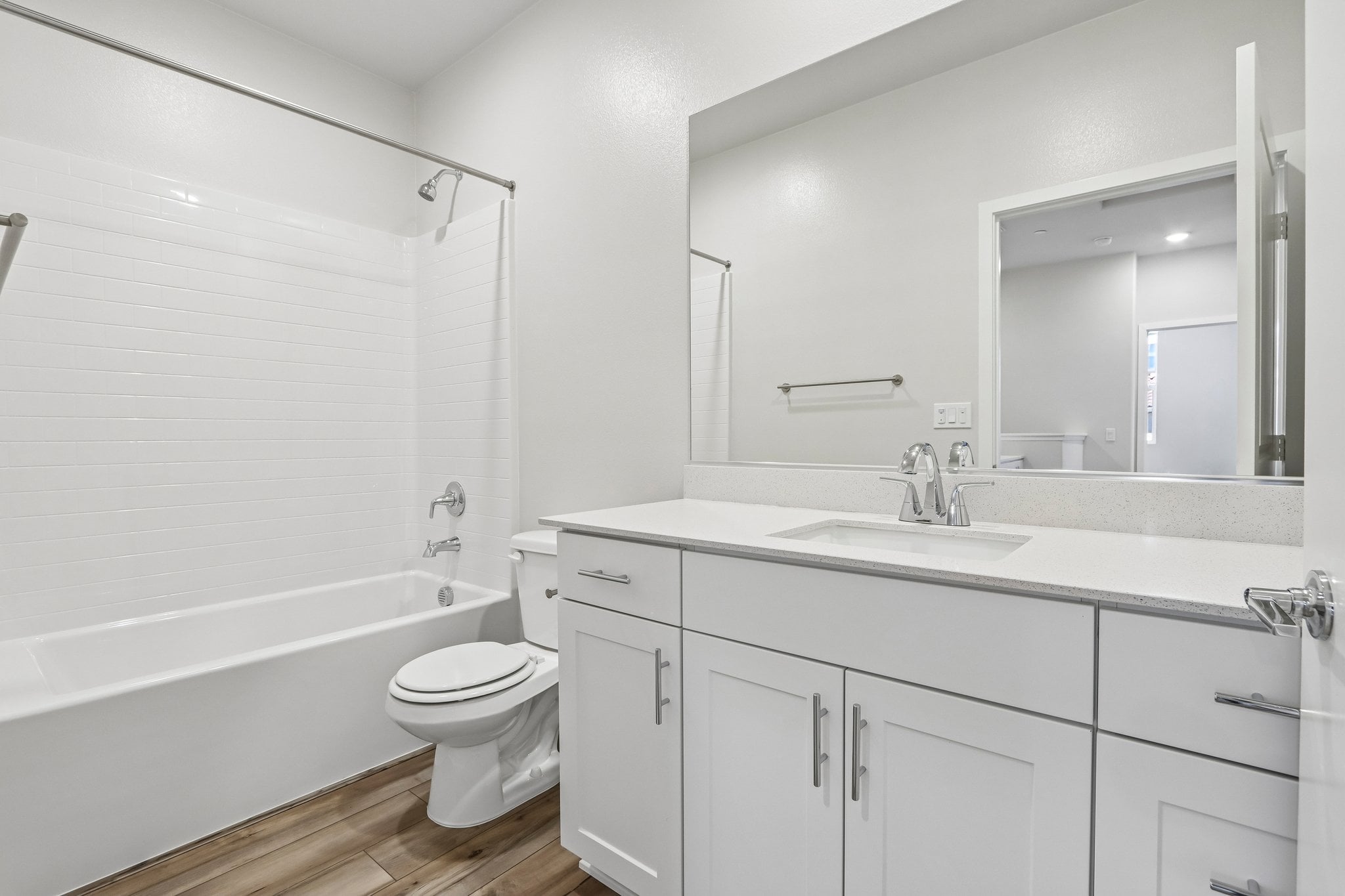 A bathroom with a tub sink and toilet.