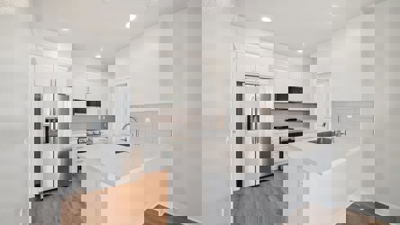 A kitchen with white cabinets.