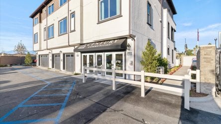 A building with a white fence.