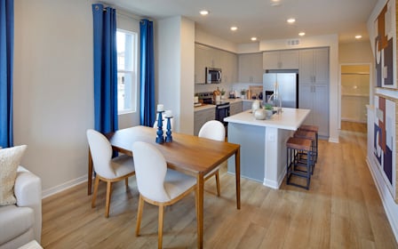 A kitchen with a dining table.