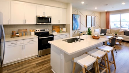 A kitchen with white cabinets.