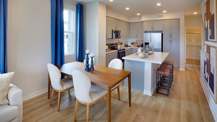 A kitchen with a dining table.