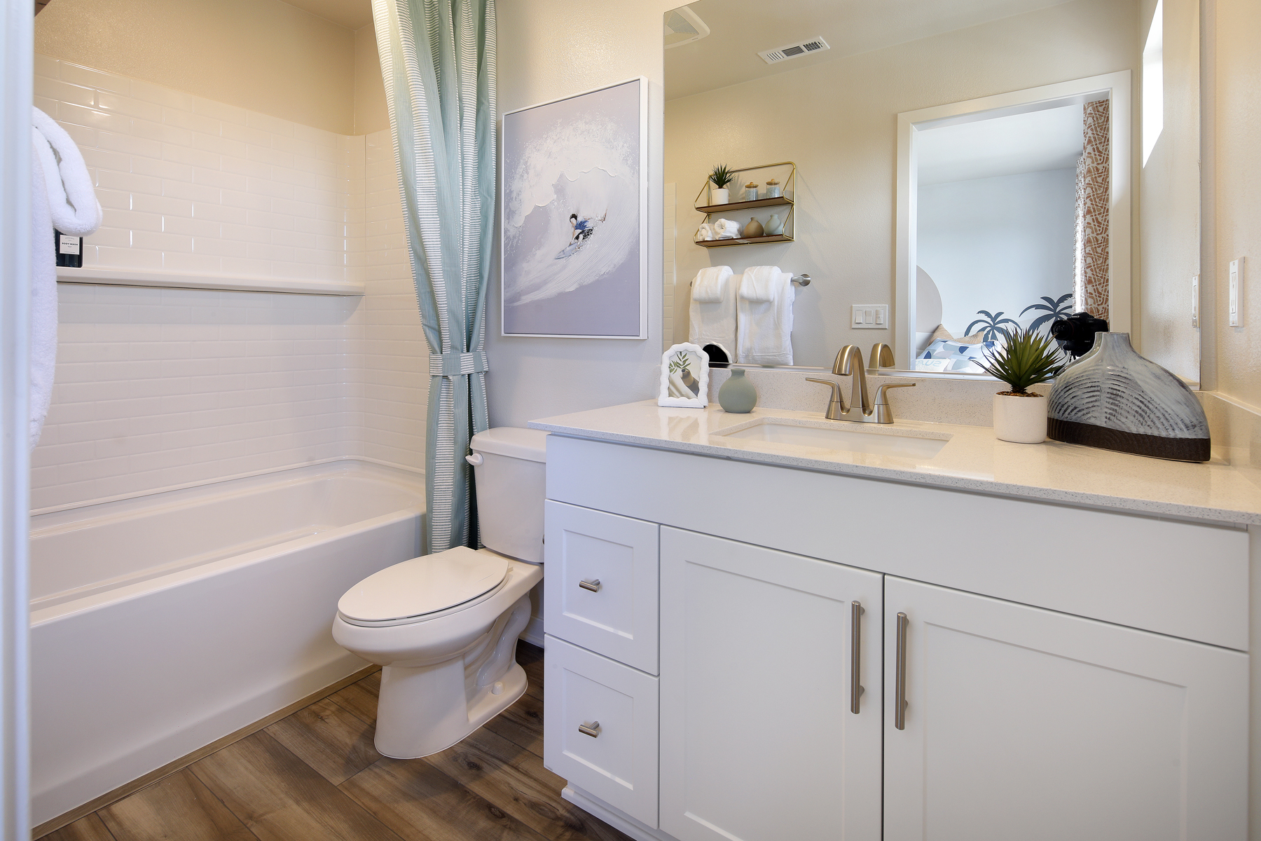 A bathroom with a tub sink and toilet.