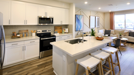 A kitchen with white cabinets.