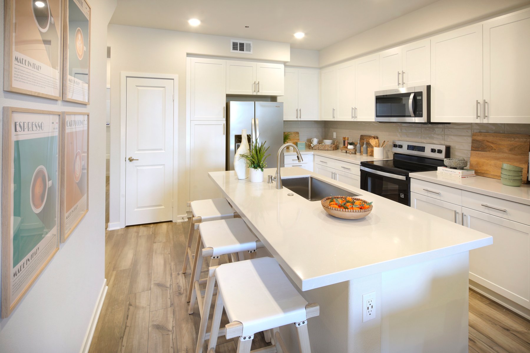 A kitchen with white cabinets.