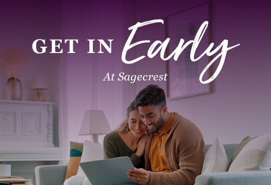 A man and woman looking at a laptop.