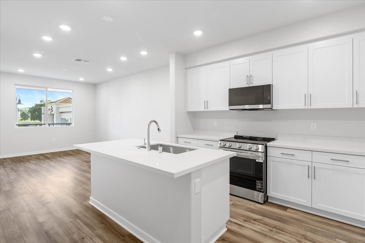 A kitchen with white cabinets.