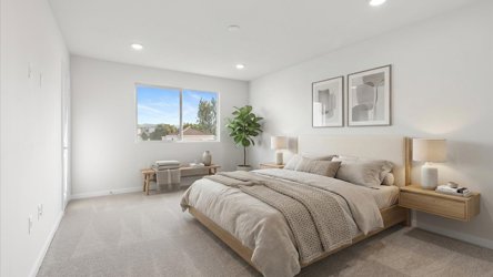 A bedroom with a bed and a desk.