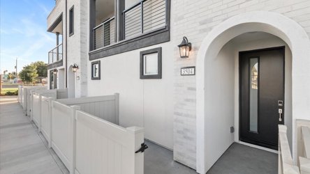 A white building with a walkway.