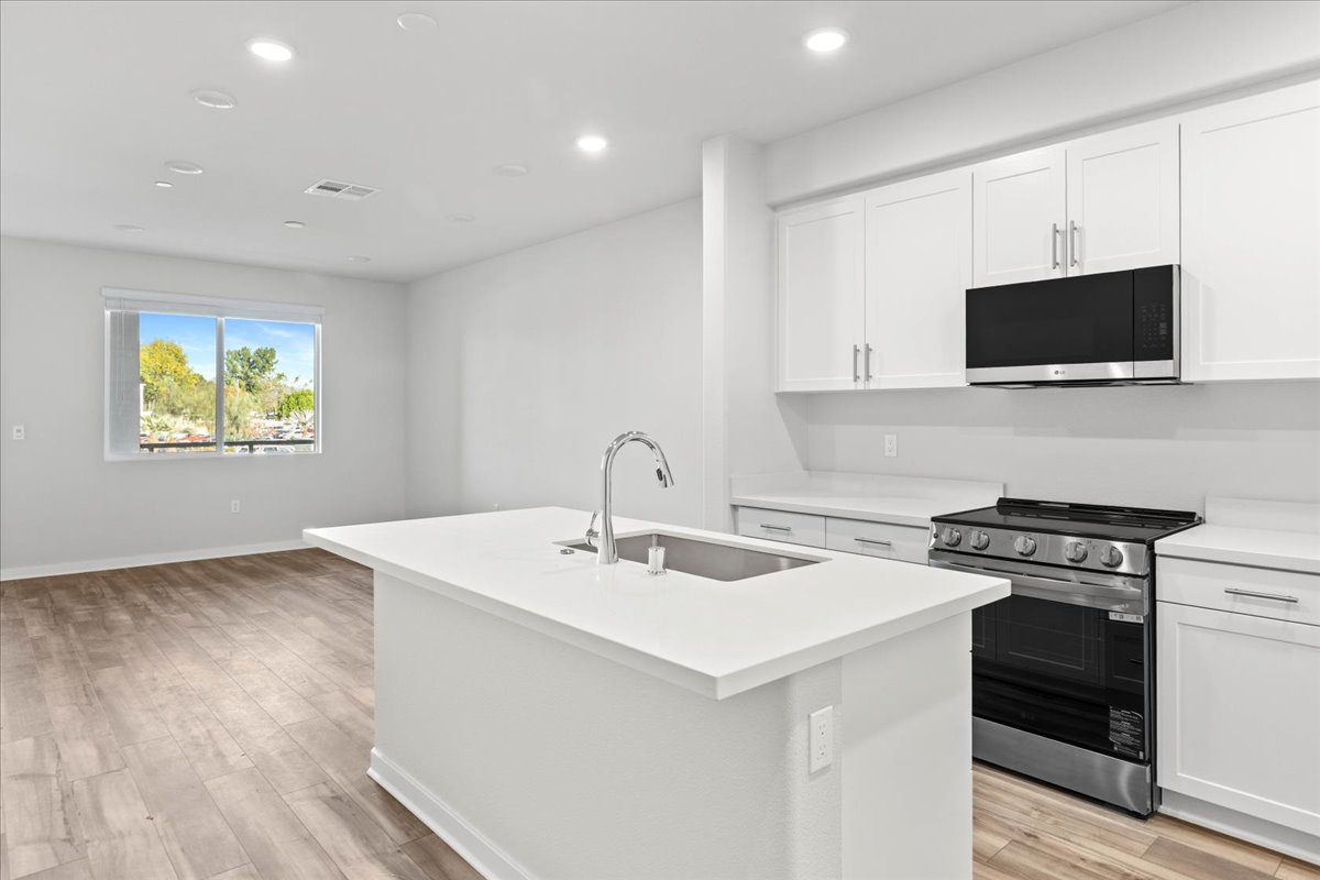 A kitchen with white cabinets.