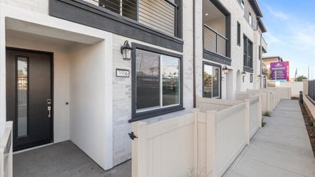 A building with a white fence.