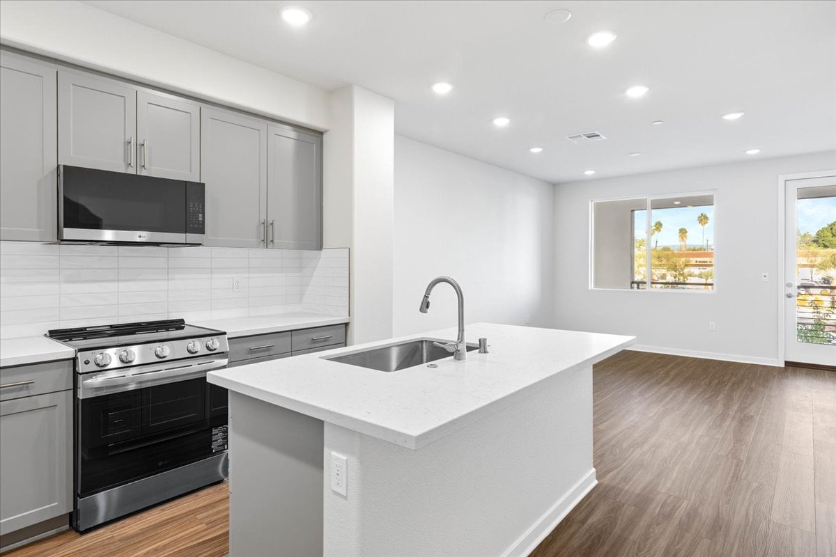 A kitchen with white cabinets.