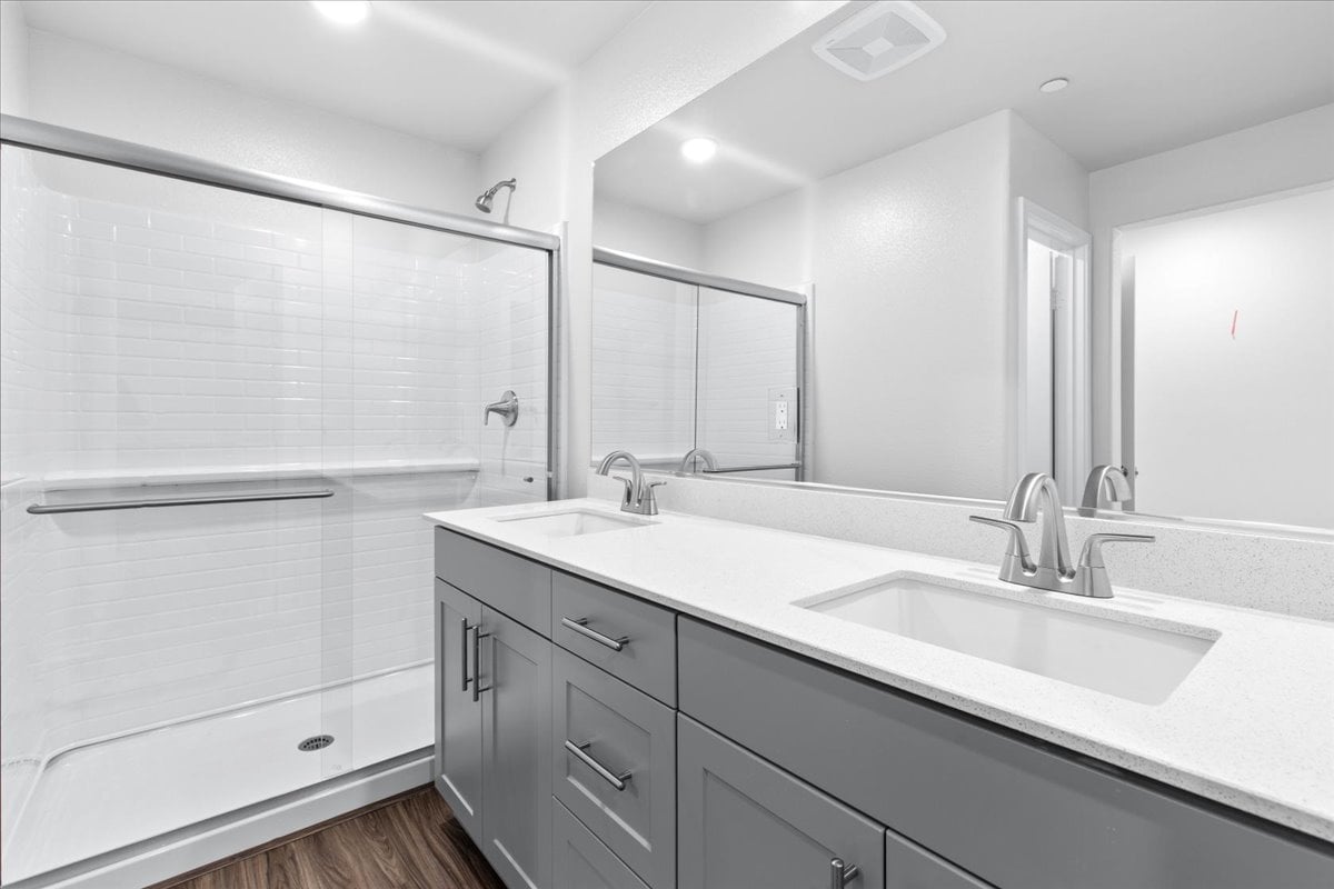 A bathroom with a large mirror.