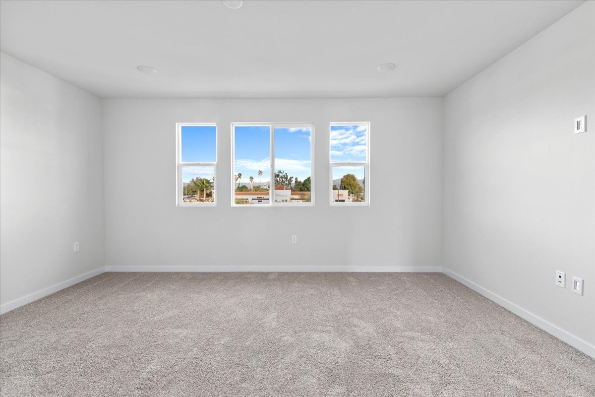 A room with a window and a carpet.