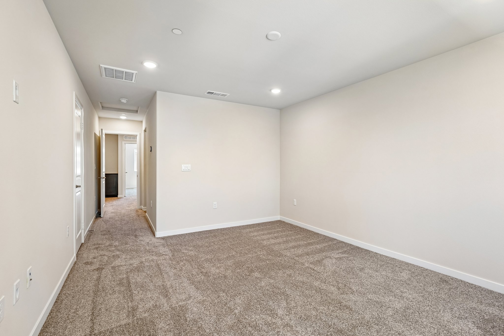 A hallway with white walls.