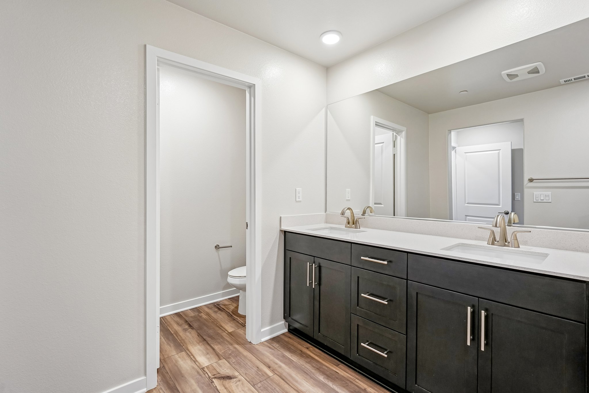 A bathroom with a large mirror.