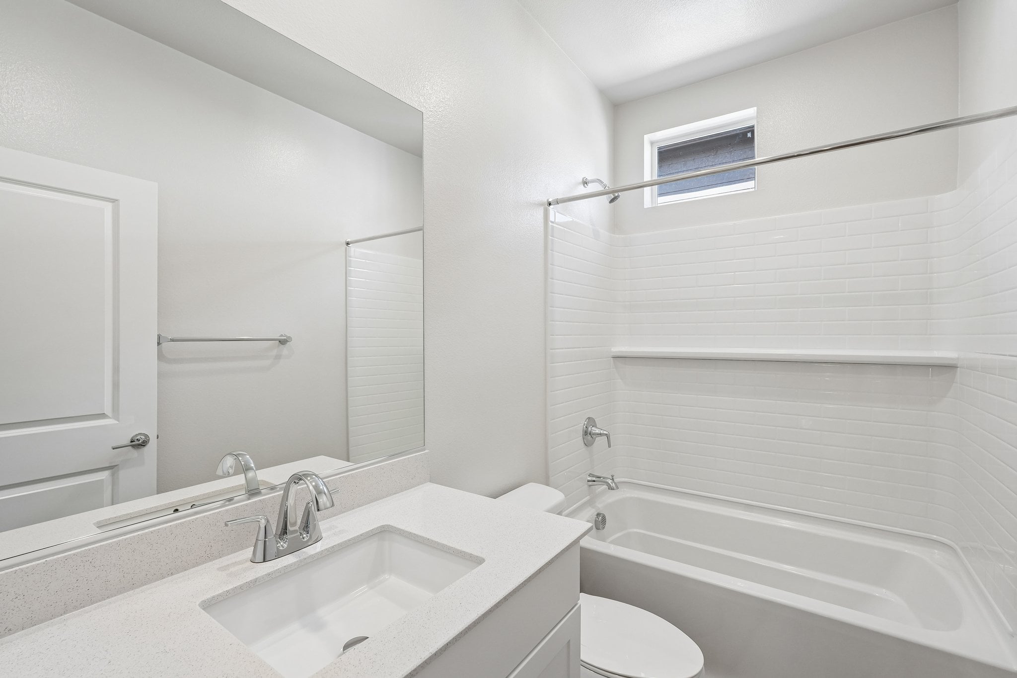 A bathroom with a tub sink and toilet.