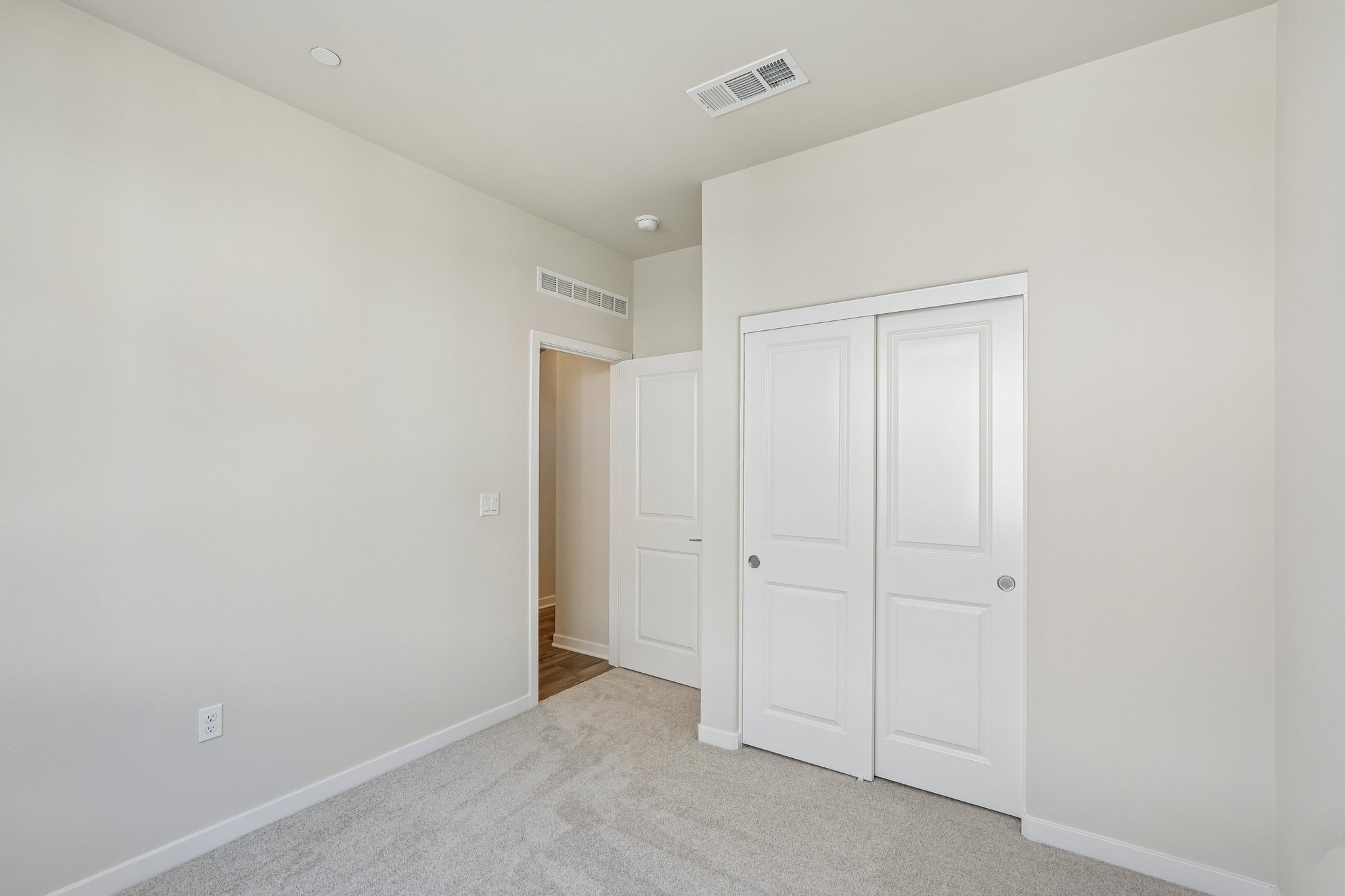 A hallway with white doors.