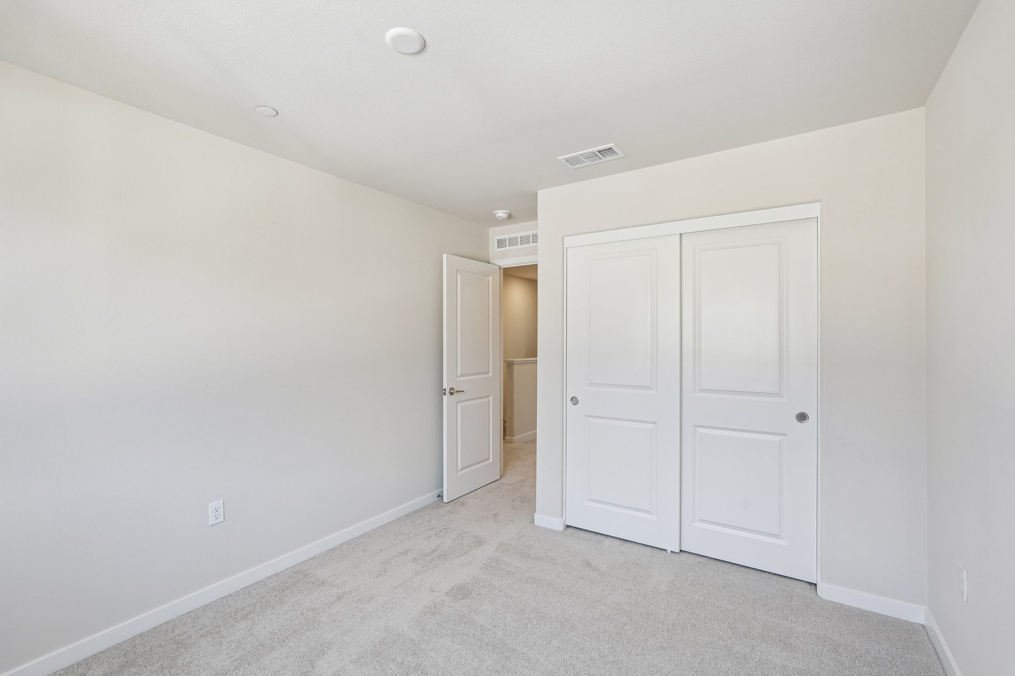 A hallway with white doors.