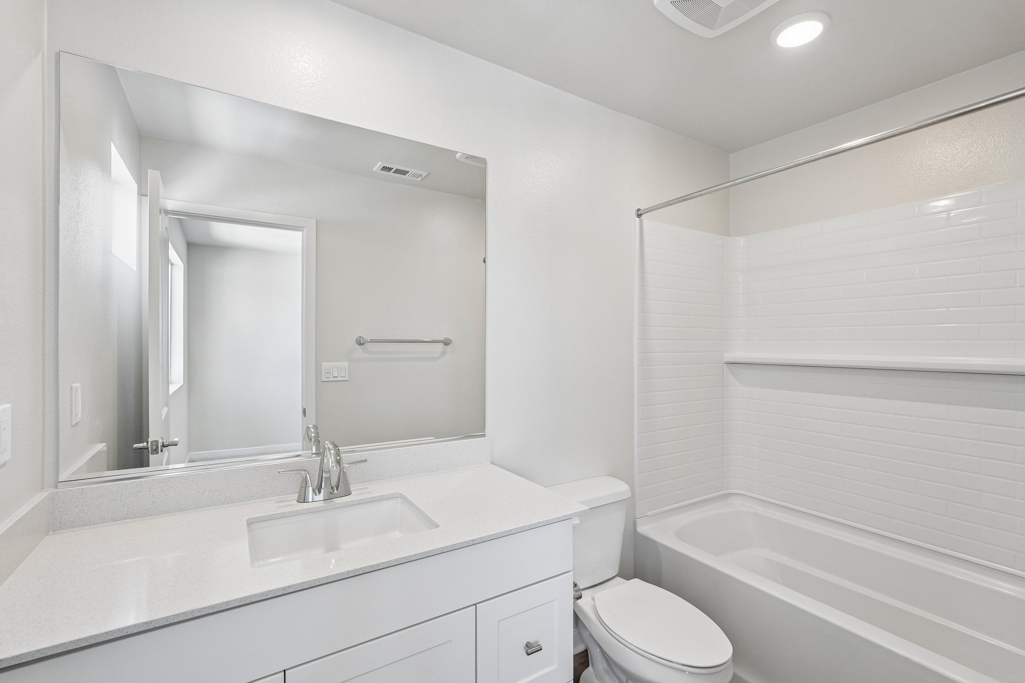 A bathroom with a tub sink and toilet.