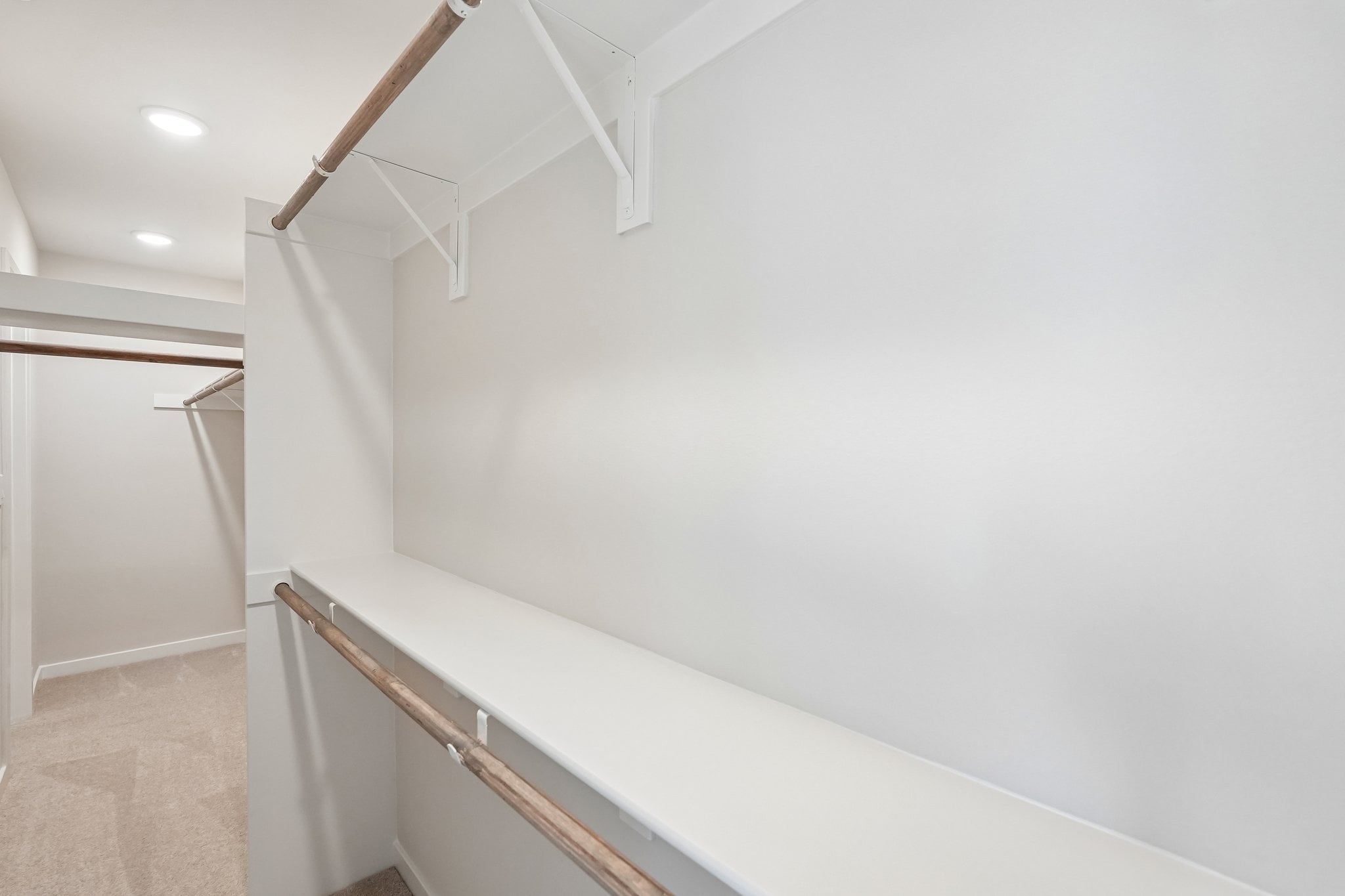 A white wall with a metal bar.