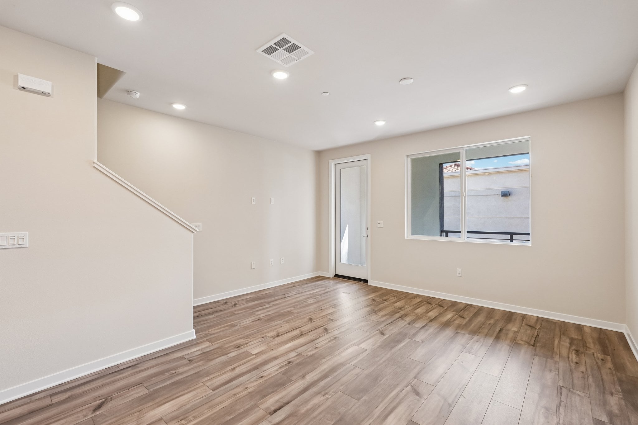 A room with a wood floor and a white door.
