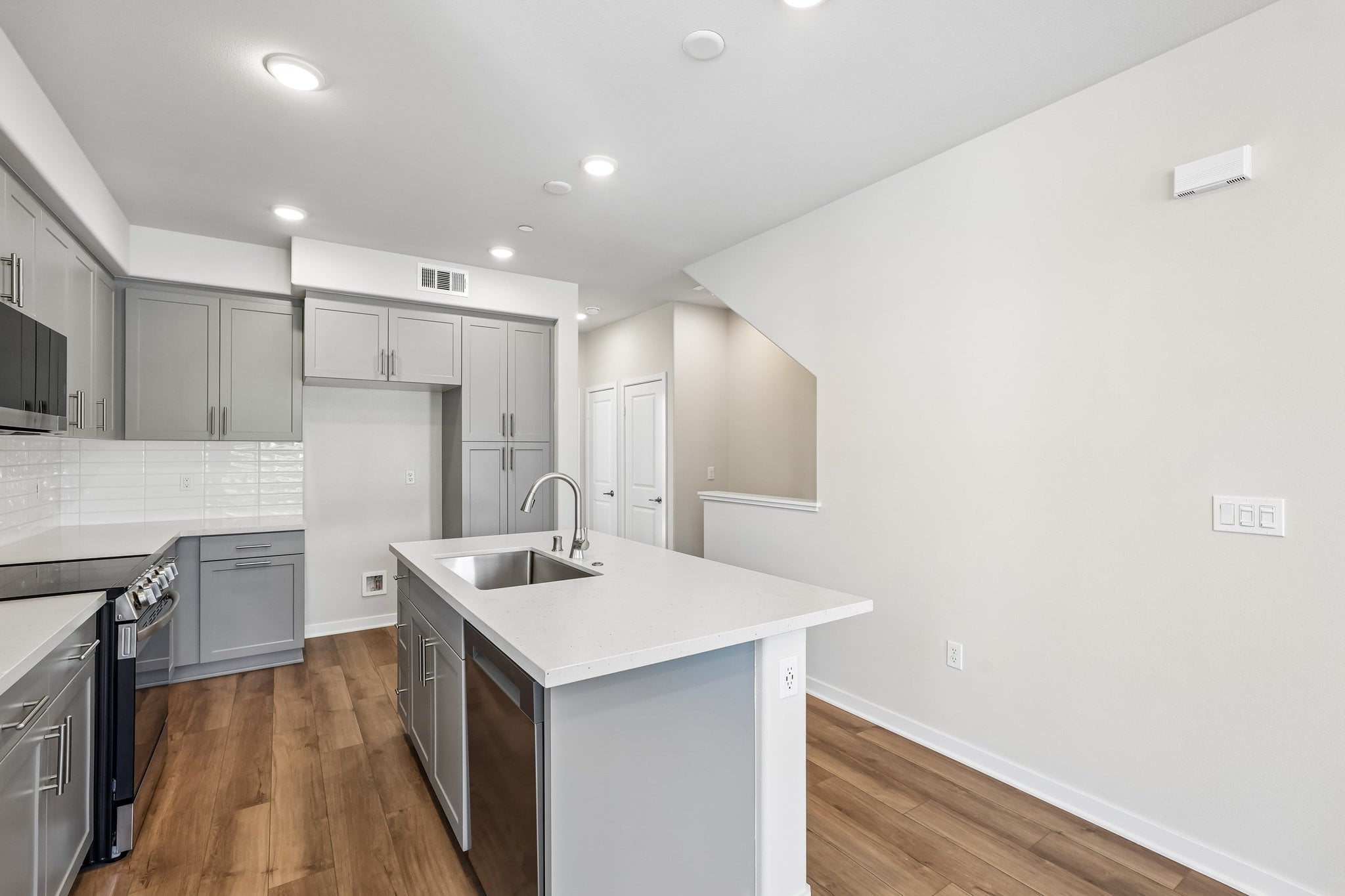 A kitchen with white cabinets.
