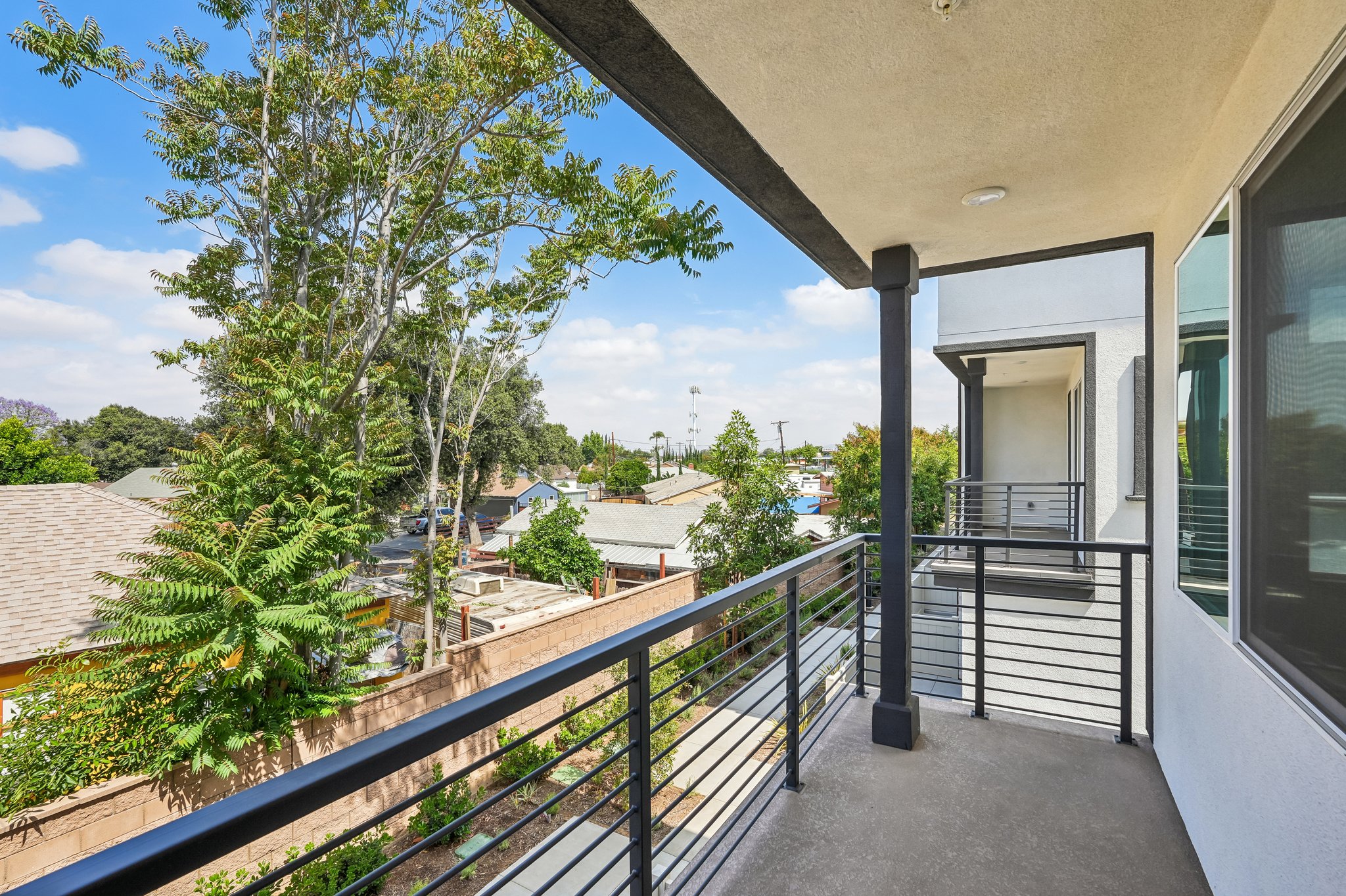 A building with a deck and trees.
