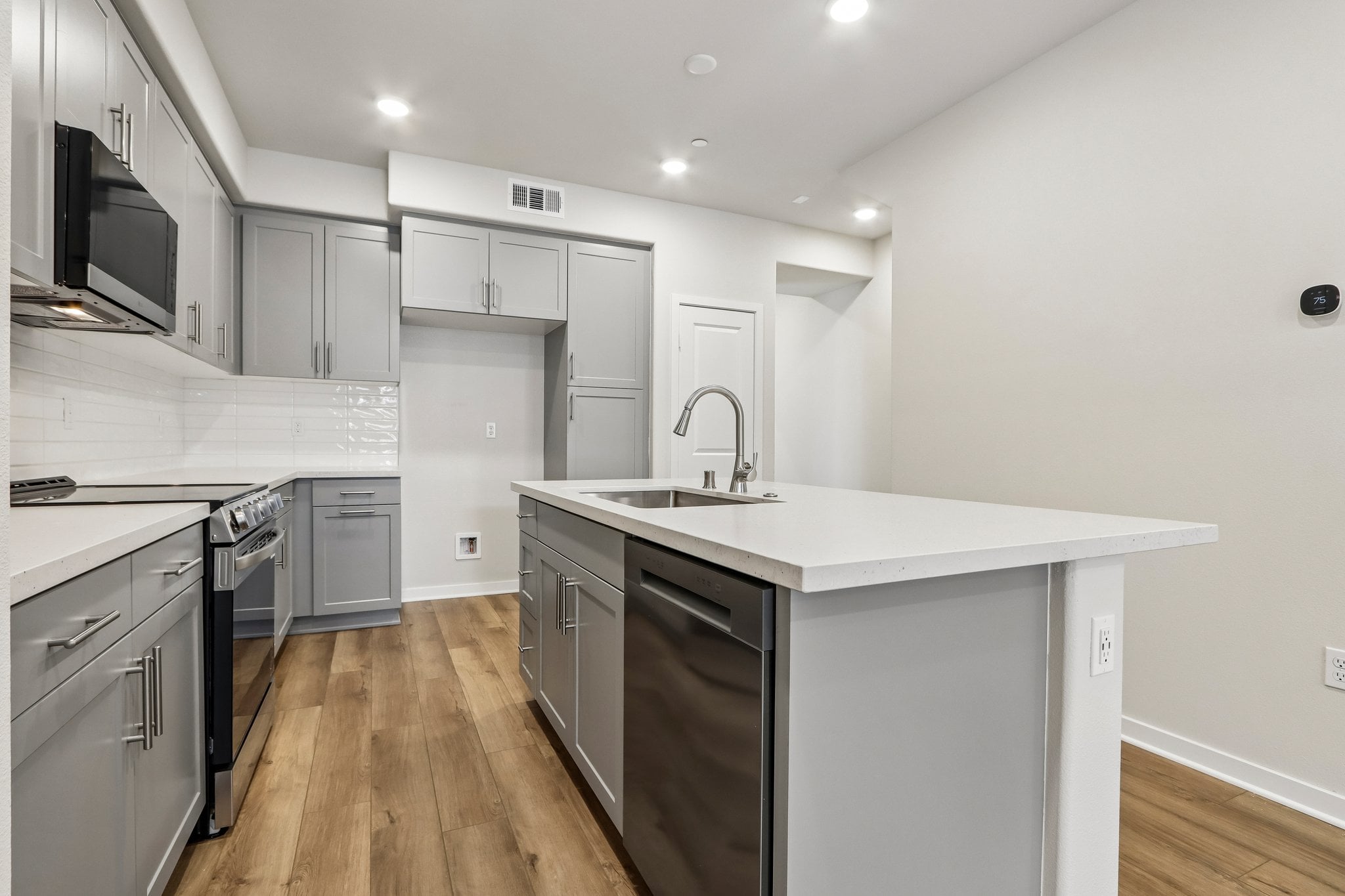 A kitchen with white cabinets.