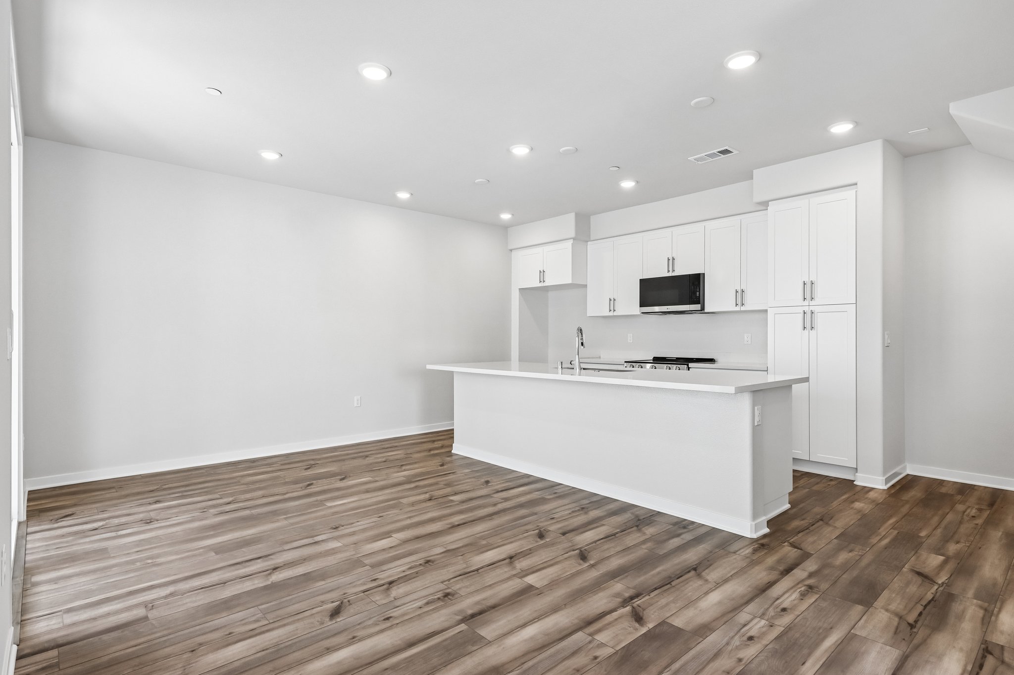 A kitchen with white cabinets.