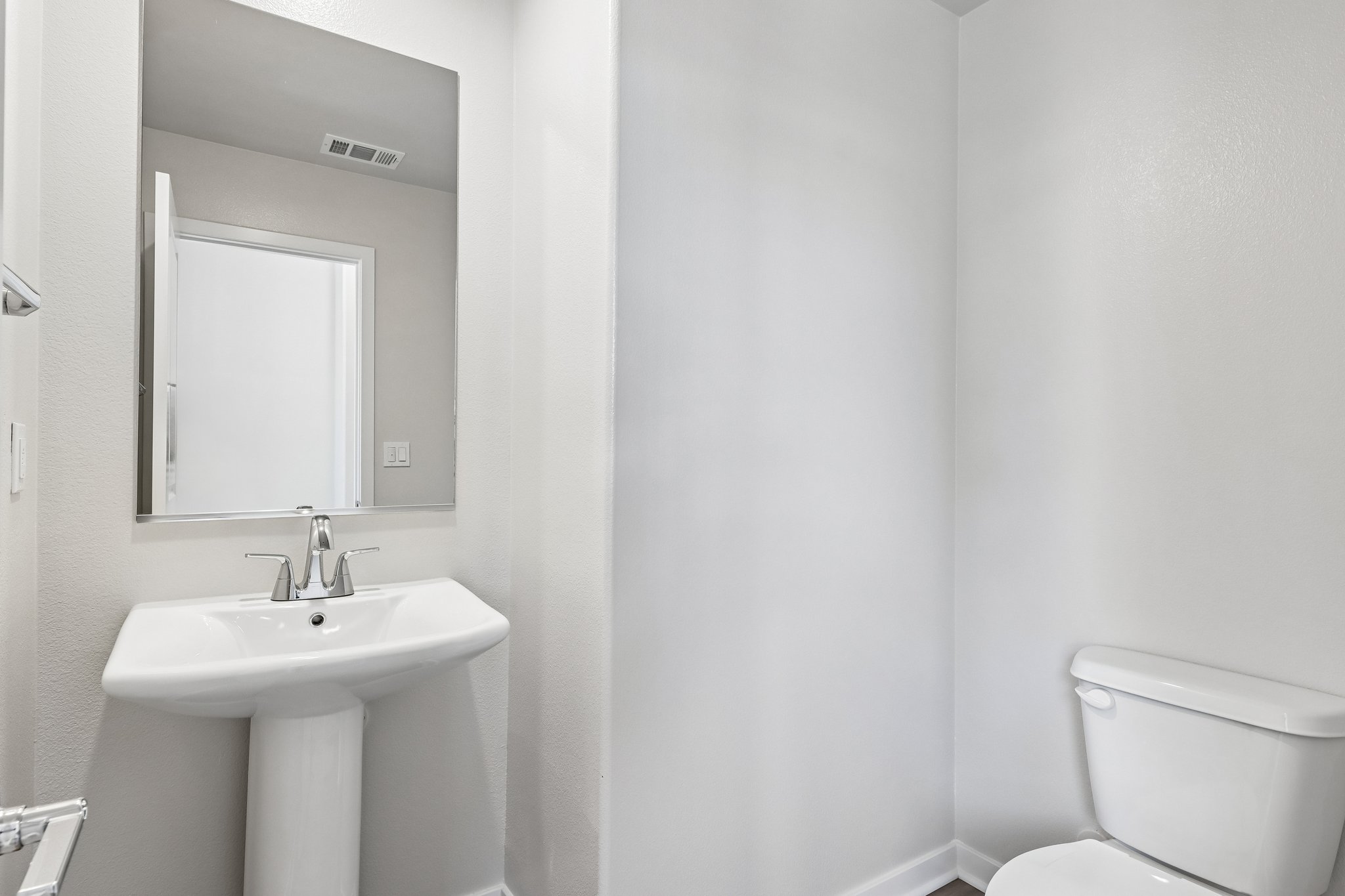 A bathroom with a sink and toilet.