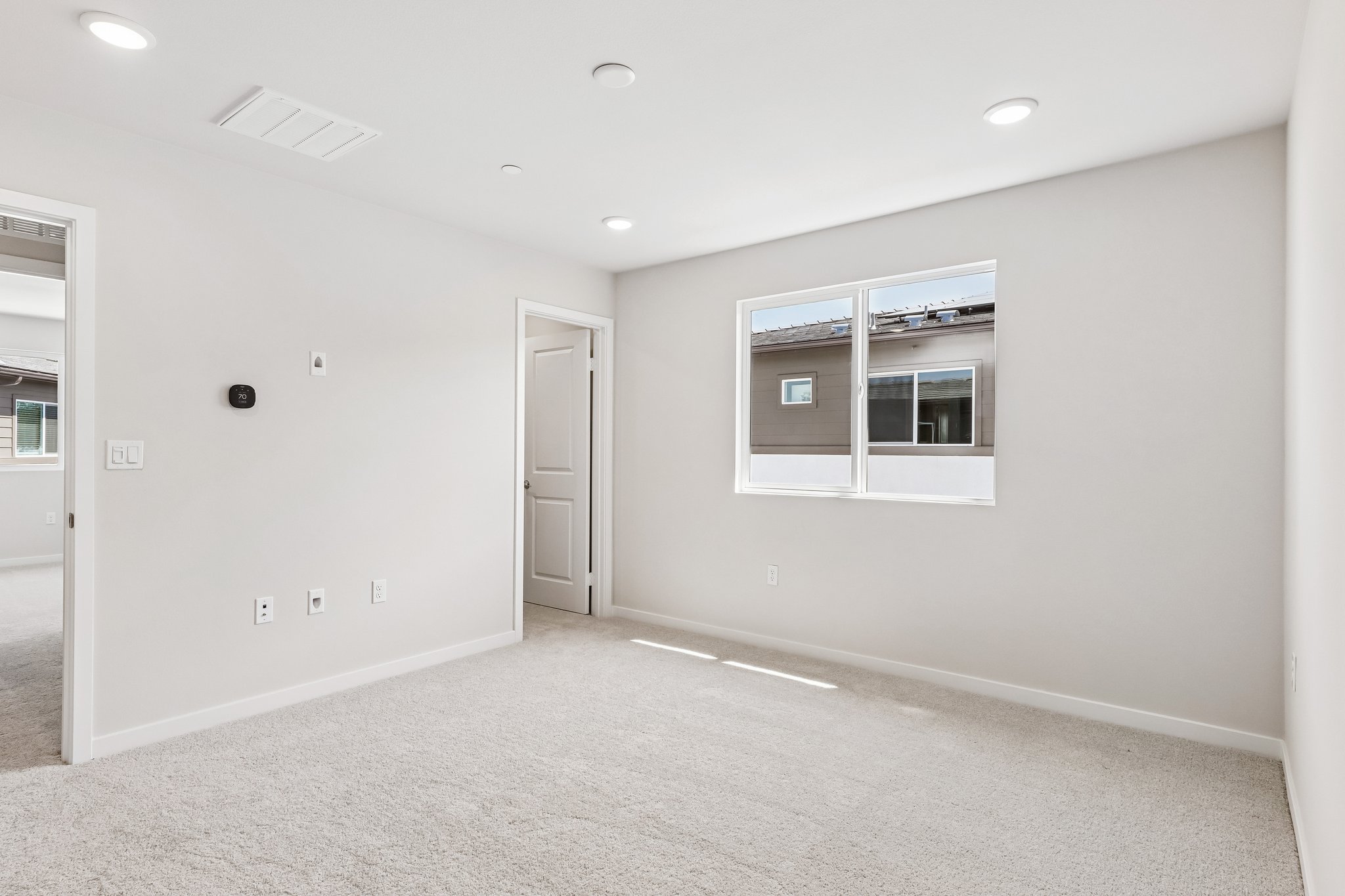 A room with a window and a door.