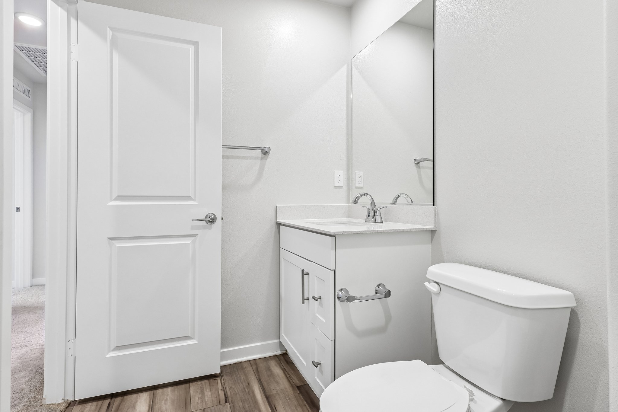 A bathroom with a toilet and sink.