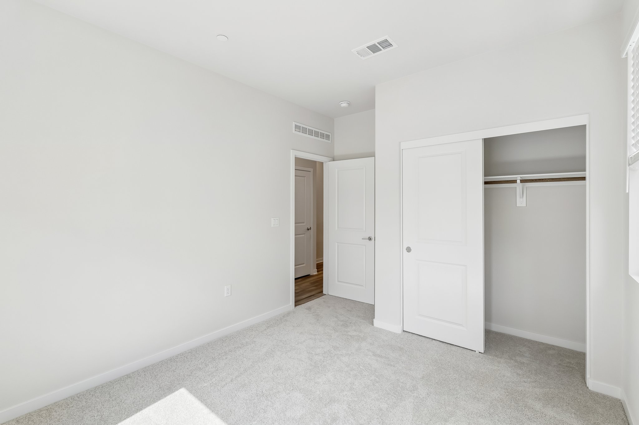 A hallway with white doors.