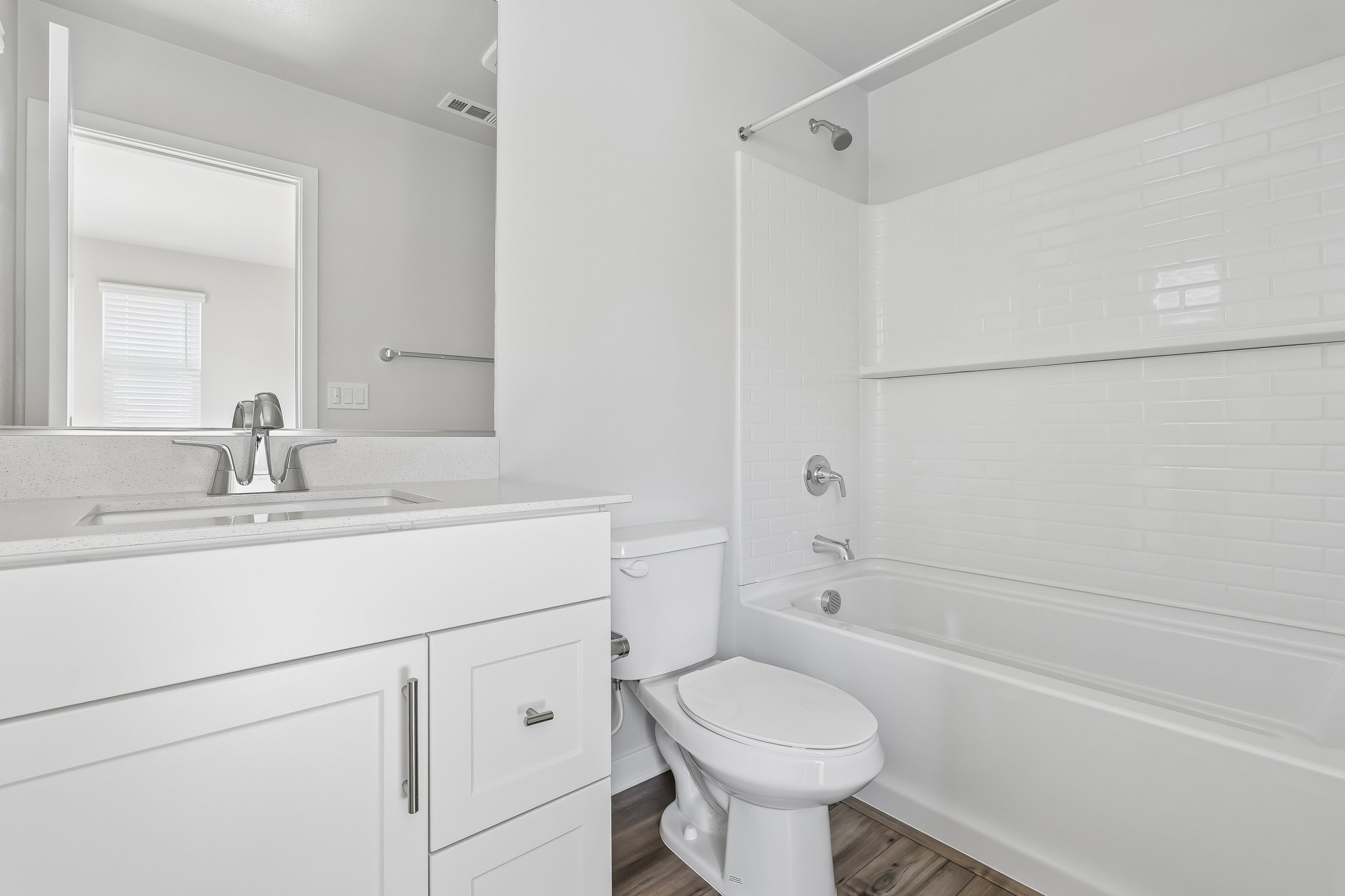 A bathroom with a tub toilet and sink.