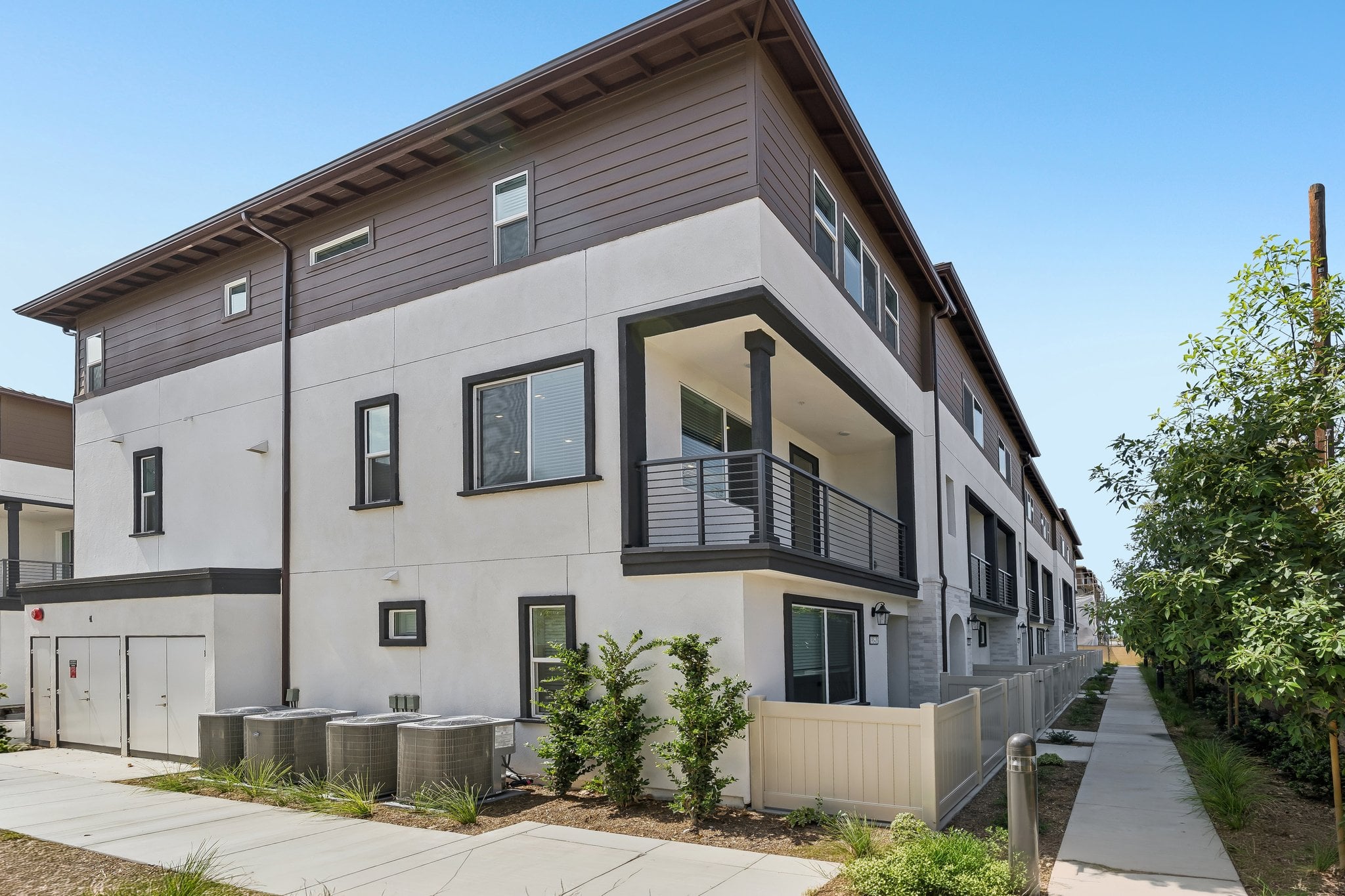 A grey house with a small balcony.