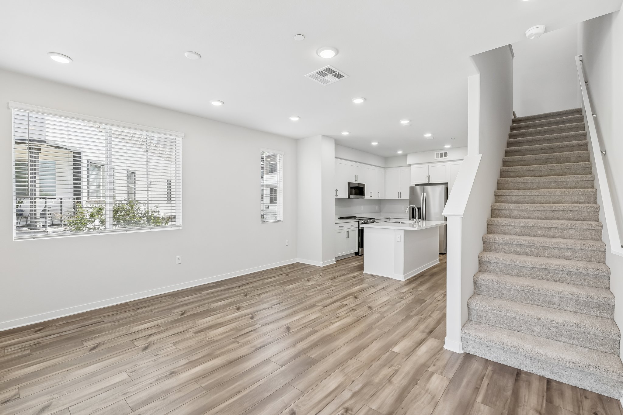 A large kitchen with wood floors.