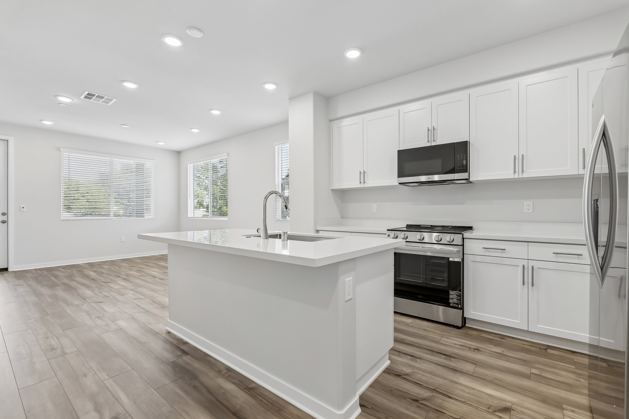 A kitchen with white cabinets.