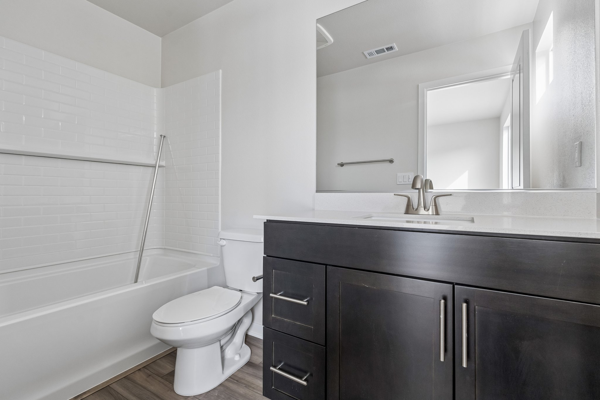 A bathroom with a tub toilet and sink.