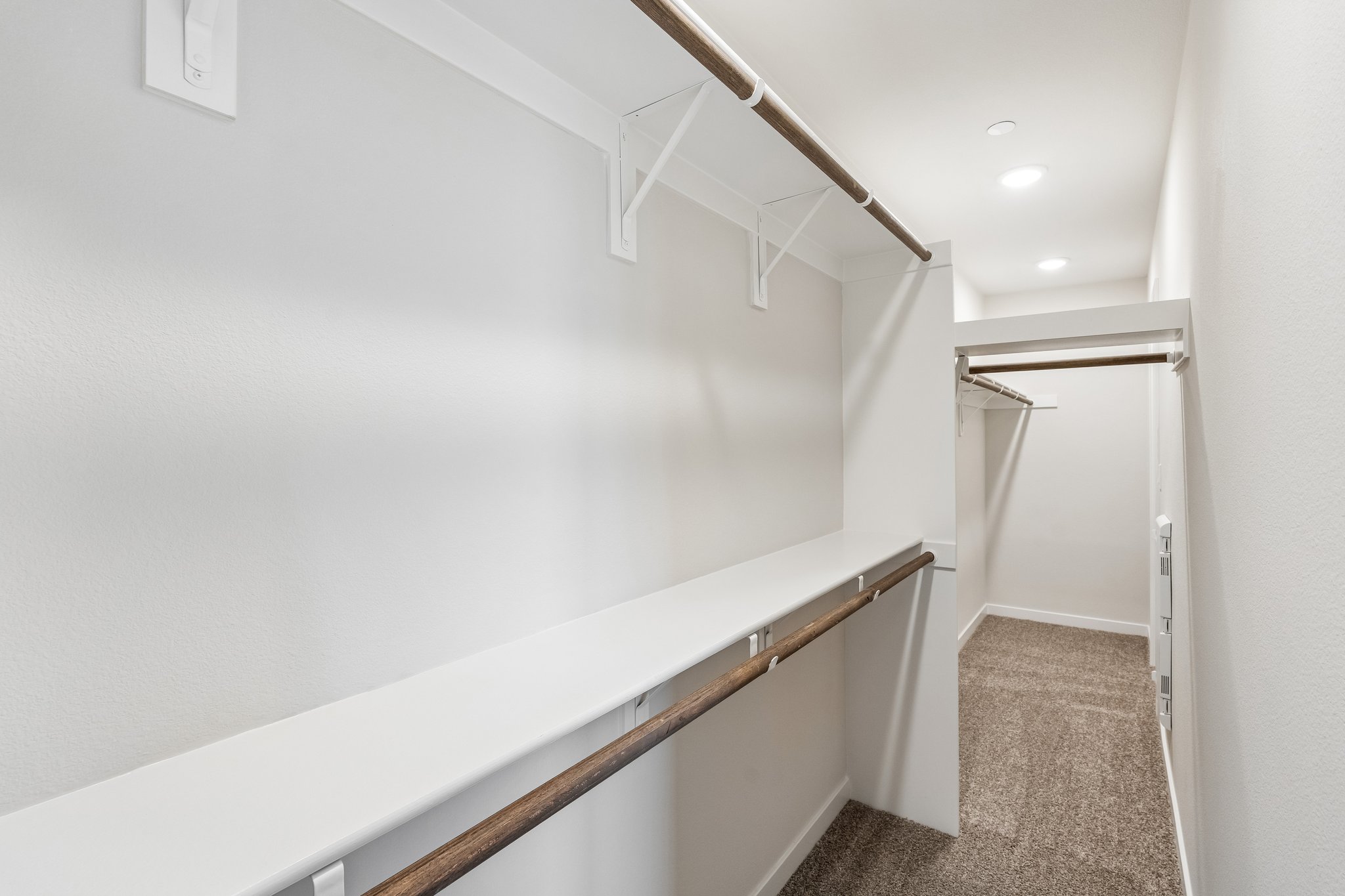 A white wall with a metal railing.
