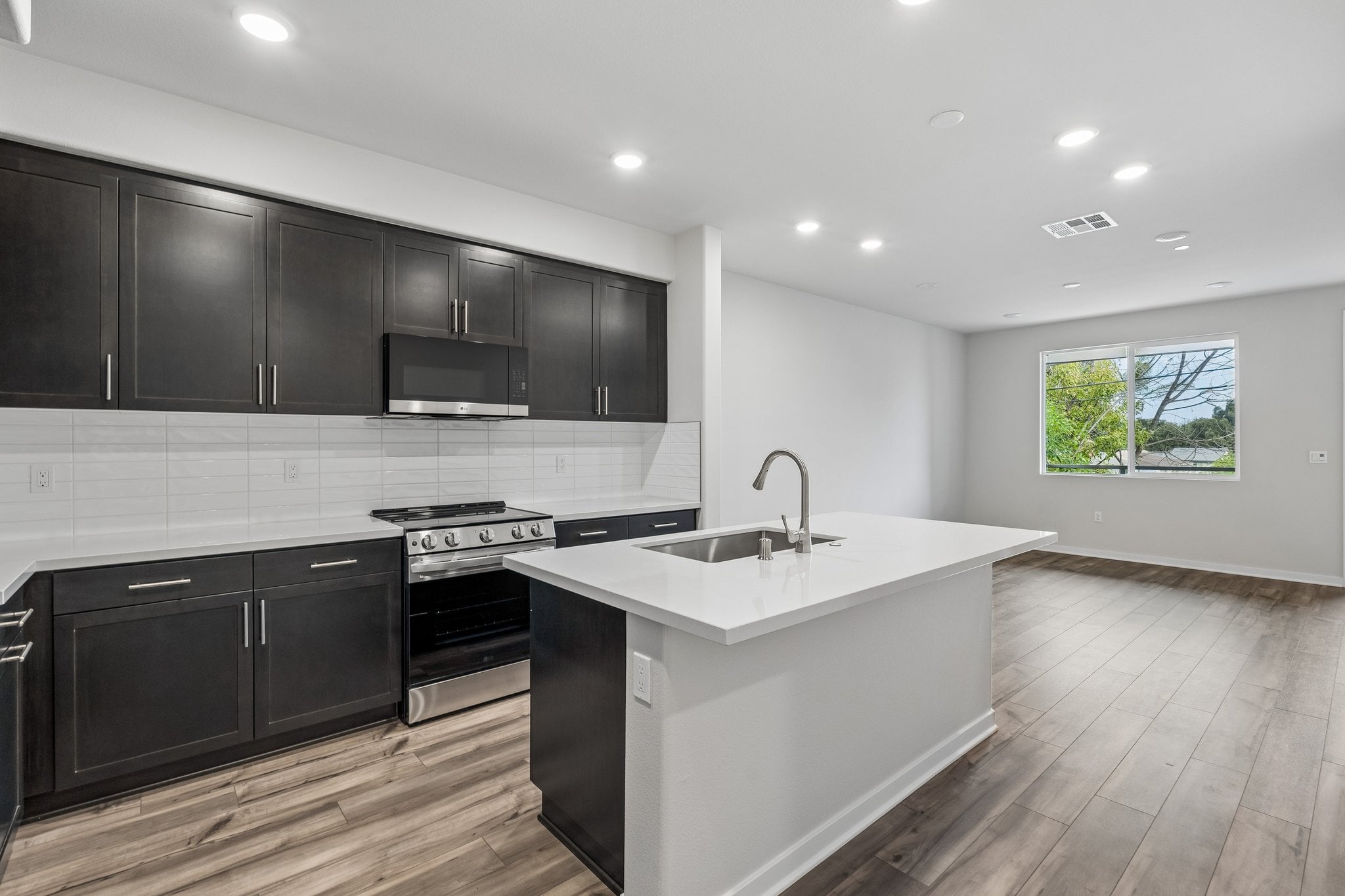 A kitchen with black cabinets.