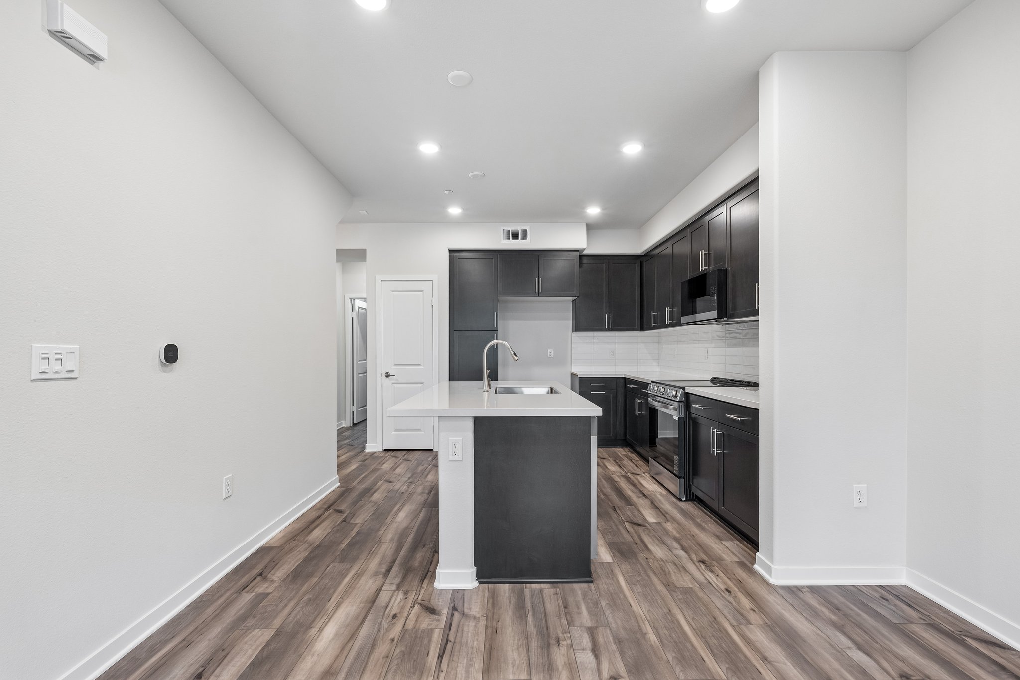 A kitchen with black cabinets.